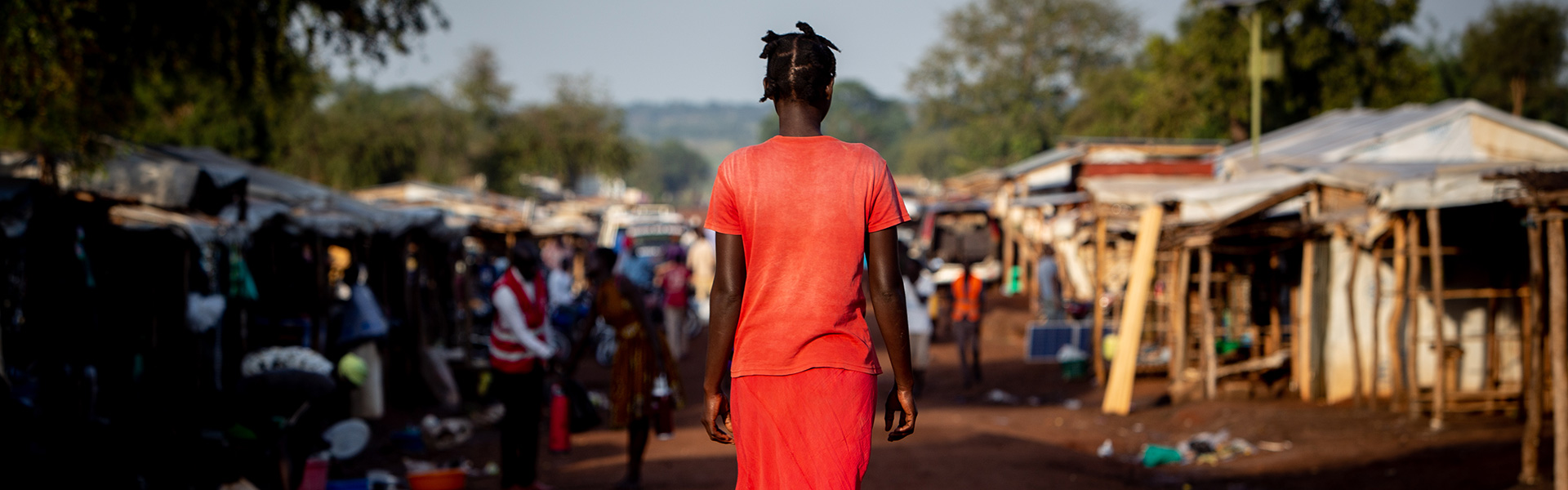 south-sudan-uganda-refugee-camp-woman-walking